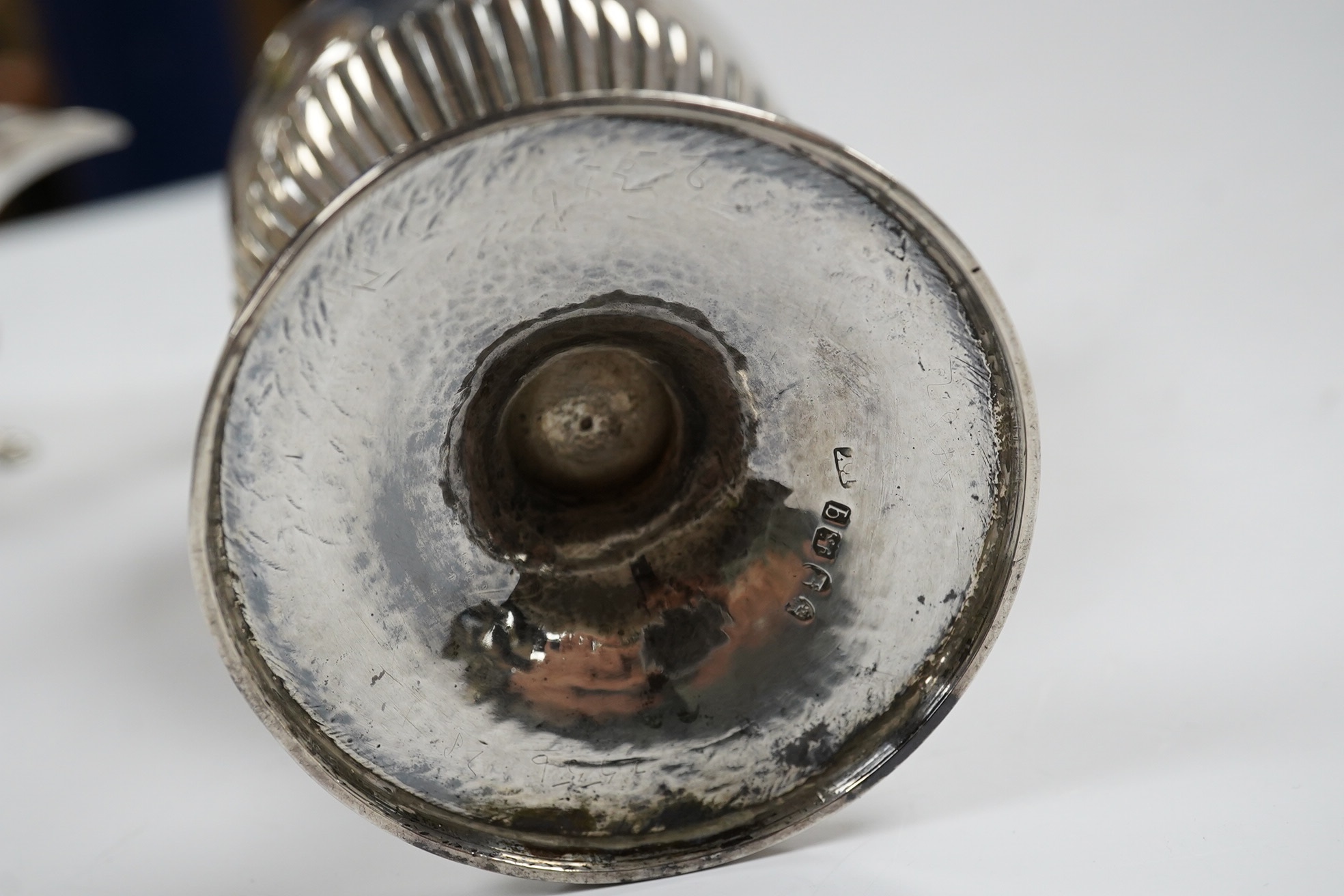 A George II small silver sauceboat, Gwillim & Castle, London, 1744, length 13.6cm, together with a George III silver hot water jug, London, 1791, gross 9.6oz. Condition - poor